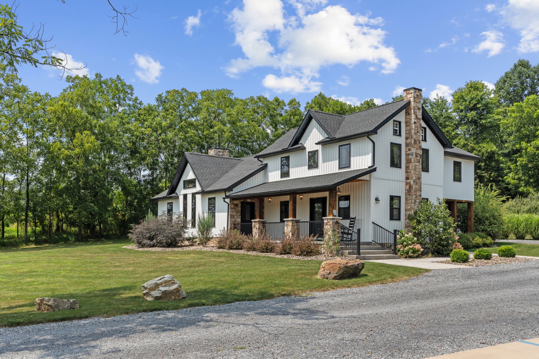 White farmhouse with wraparound porch