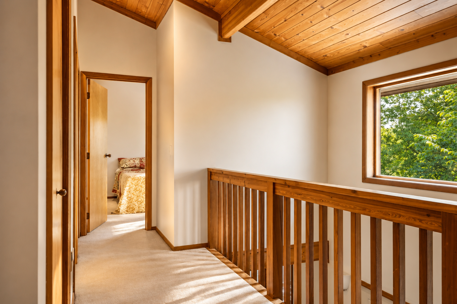 Upstairs hallway with wood ceiling and railing
