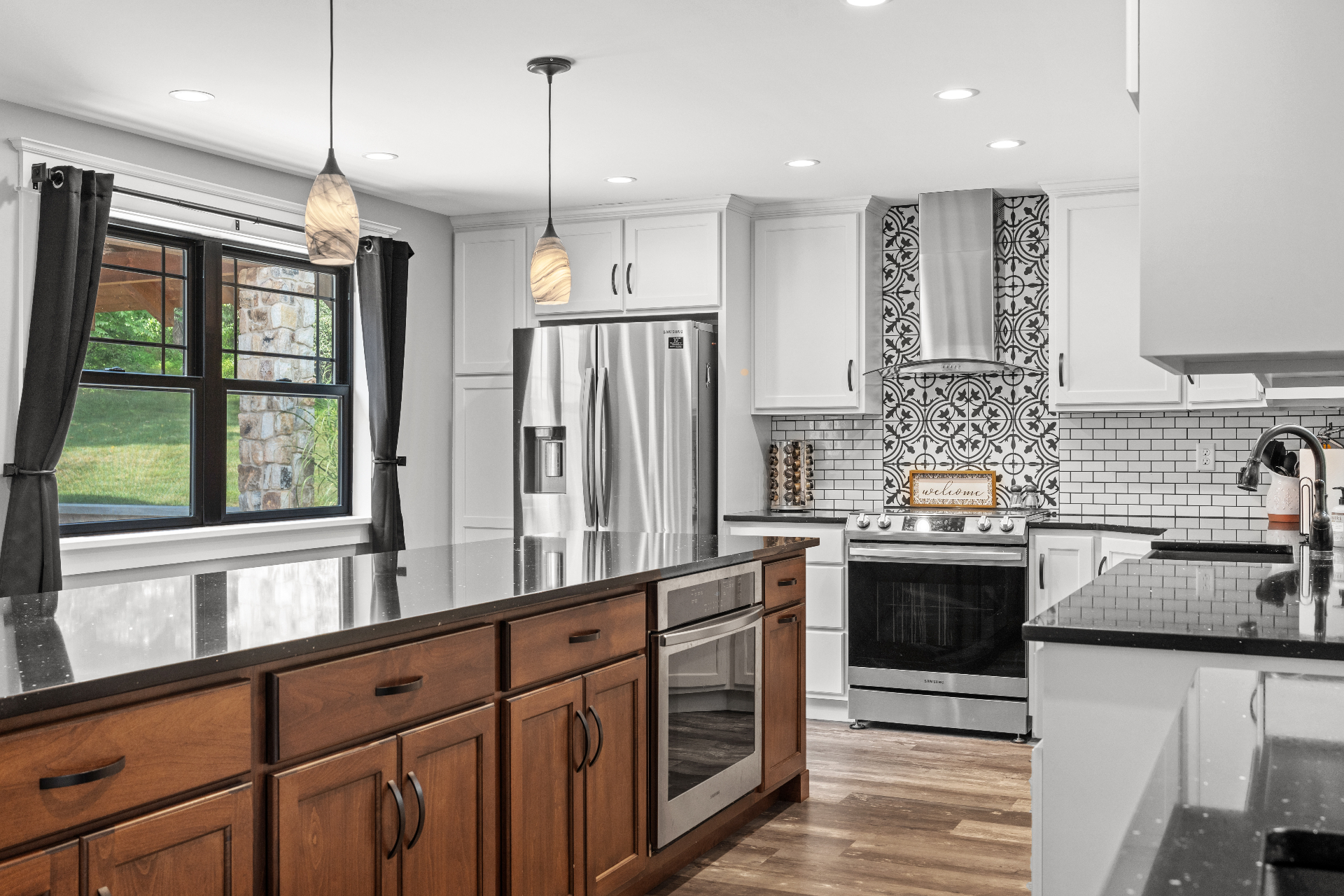 Kitchen island with pendant lights and patterned backsplash