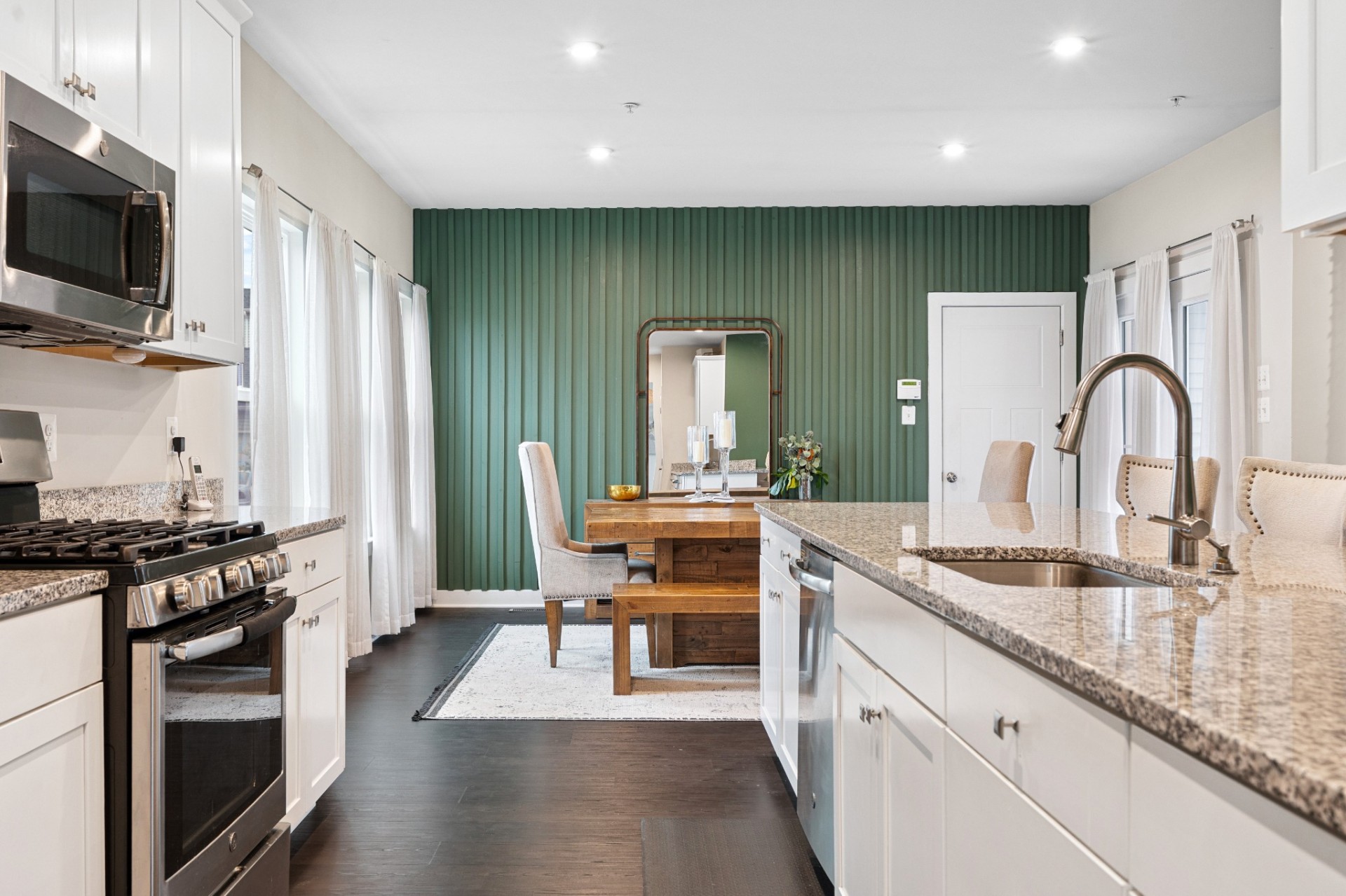 Kitchen with green slat accent wall and dining nook